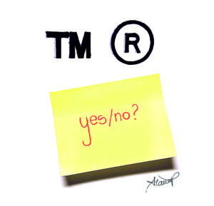 Trademark symbols in academic writing with sticky note saying yes or no